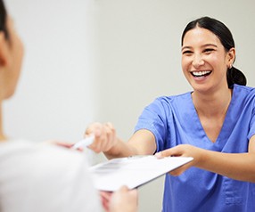 Patient in Tyler talking to front desk about dental crowns