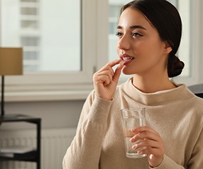 Woman taking a pill