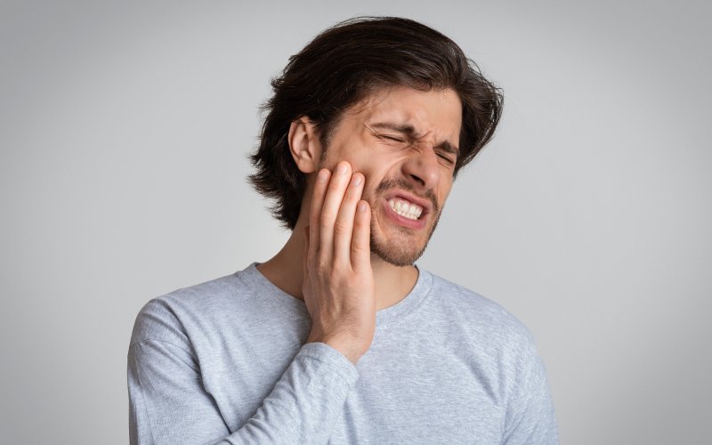 A young man with a very severe toothache